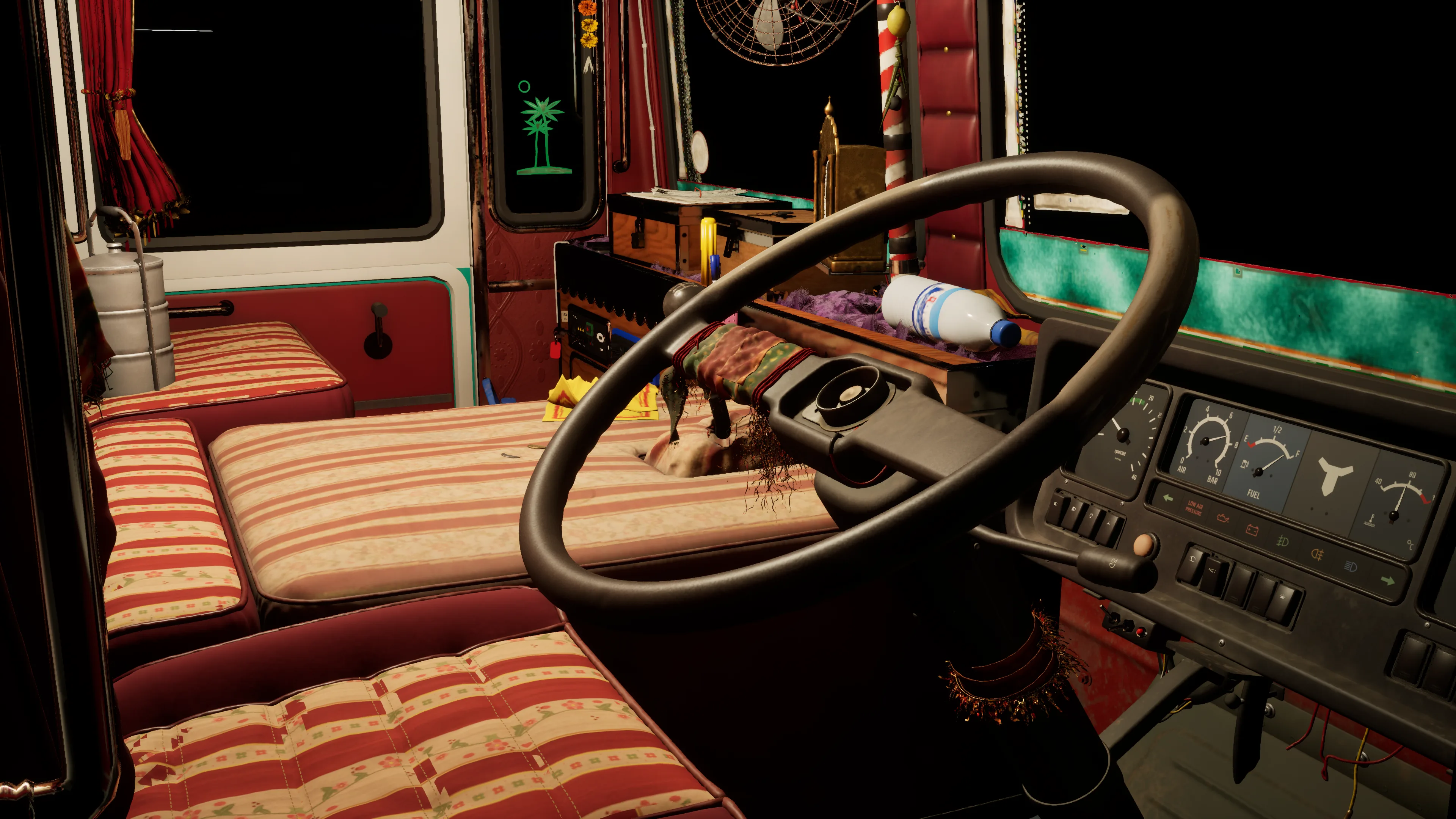 The cab at night through the open driver’s door: the steering wheel, striped bench seats and the gauges
