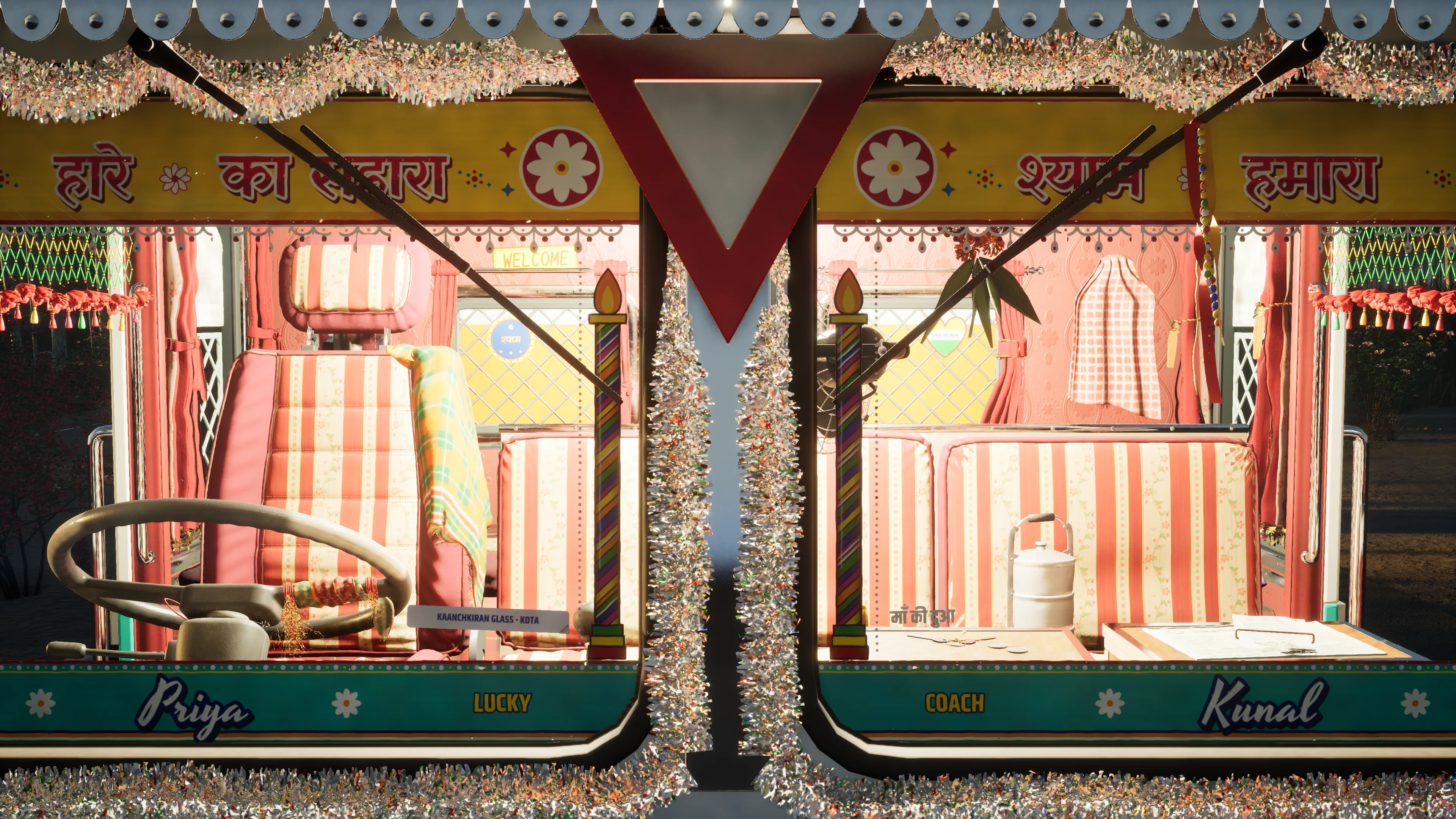 The truck’s windscreen from outside, framed in tinsel, with a Hindi slogan on a yellow band above it