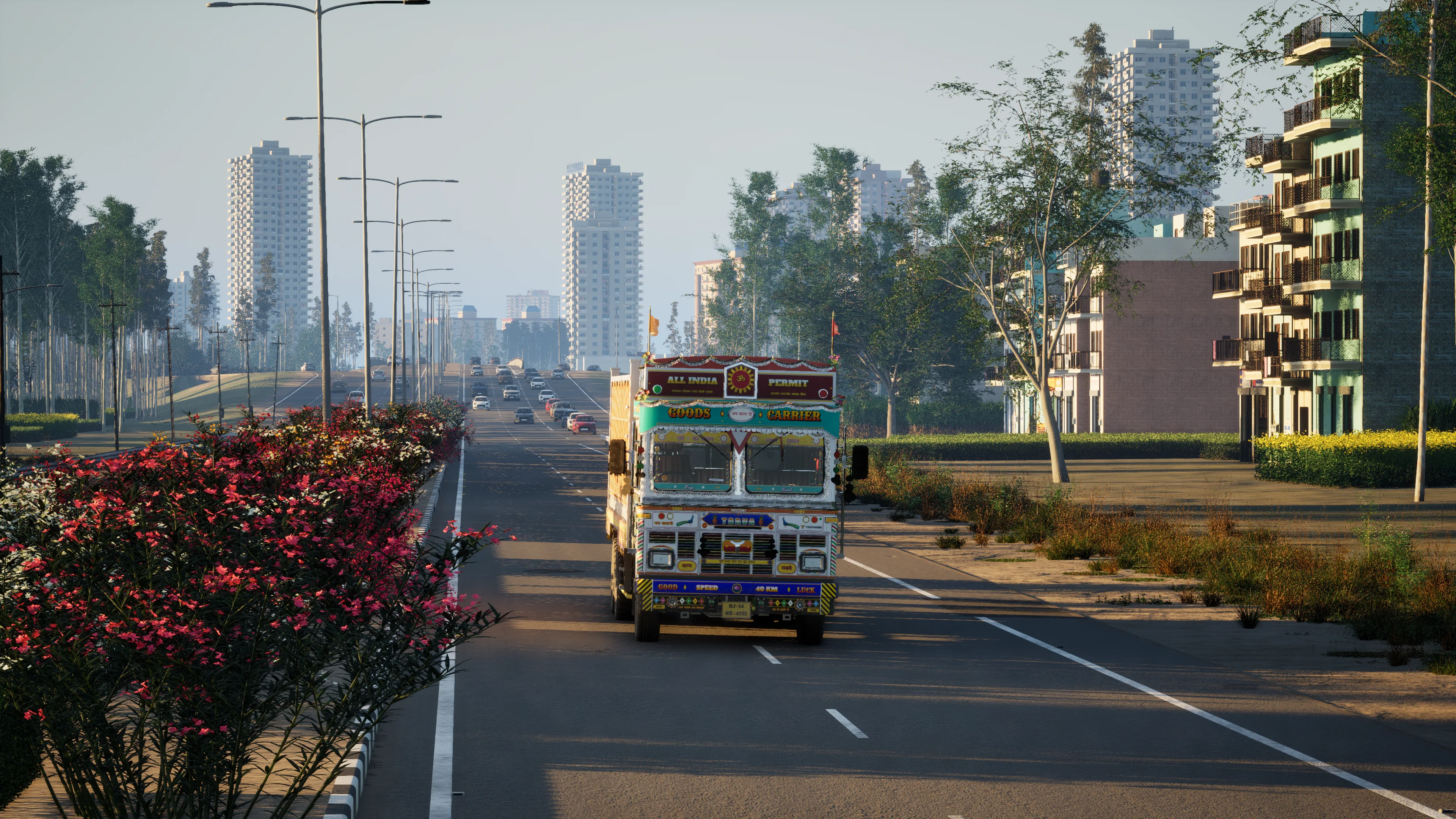 A painted truck with an ALL INDIA PERMIT board coming towards the camera on a divided city road at golden hour, cars queued behind it and apartment towers in the haze