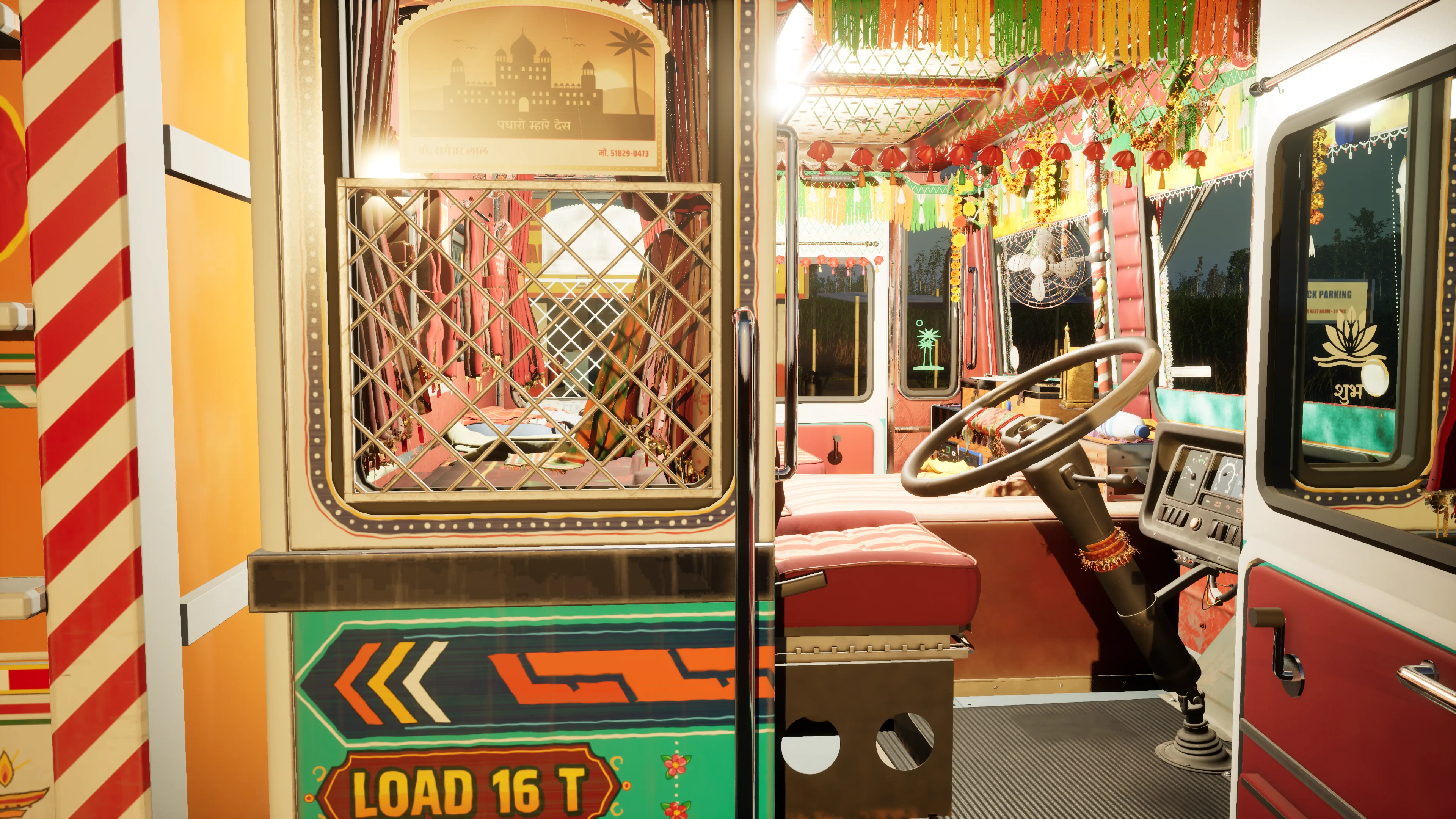 A green cab panel painted LOAD 16 T below a lattice window and a framed poster, beside the open doorway into a decorated cab with a steering wheel and fringe